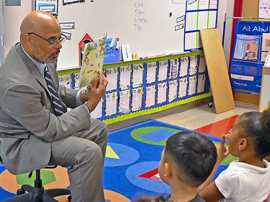  This is a photo of James Colbert reading to children